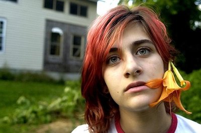 colour portrait of girl with red hair and a tiger lily